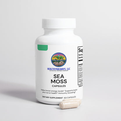 A white bottle of Sea Moss capsules from Healthy8Always sits on a gray surface, its label promoting energy support and immunity boosting. Two capsules enhanced with Bladderwrack rest in front for added vitality.